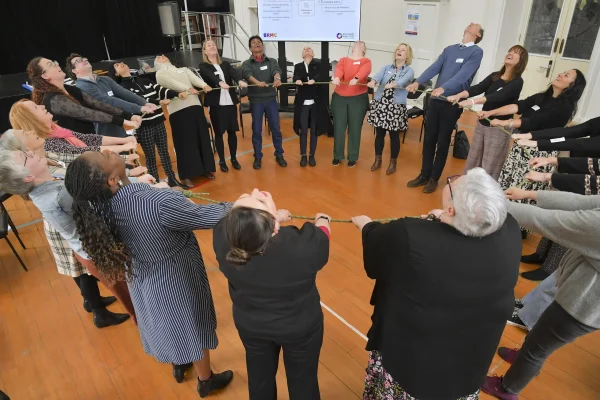 Team-building exercise with a group pulling rope together.