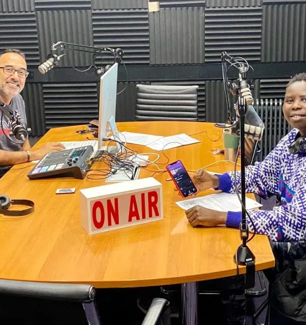 Two people in radio studio with microphones.