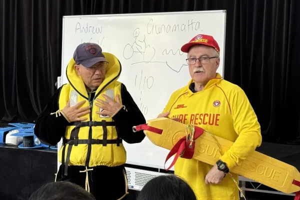 Two men in safety gear at rescue demonstration.
