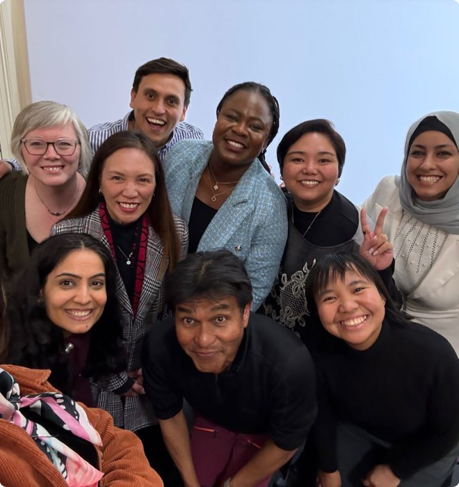 Diverse group of people smiling together indoors.
