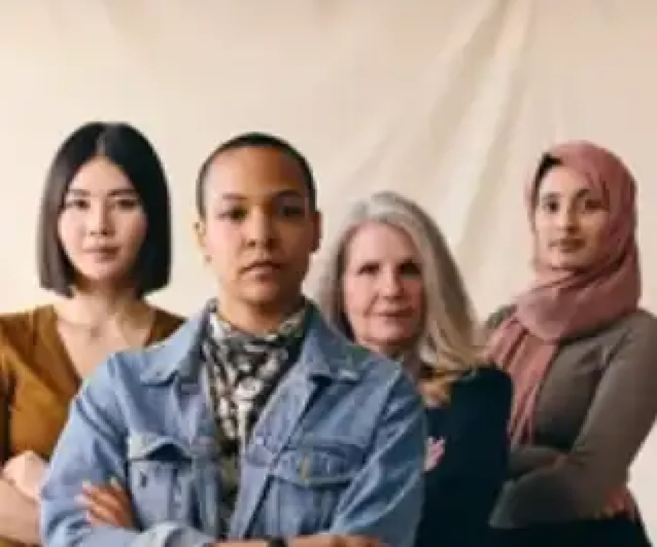 Diverse group of four confident women standing together.