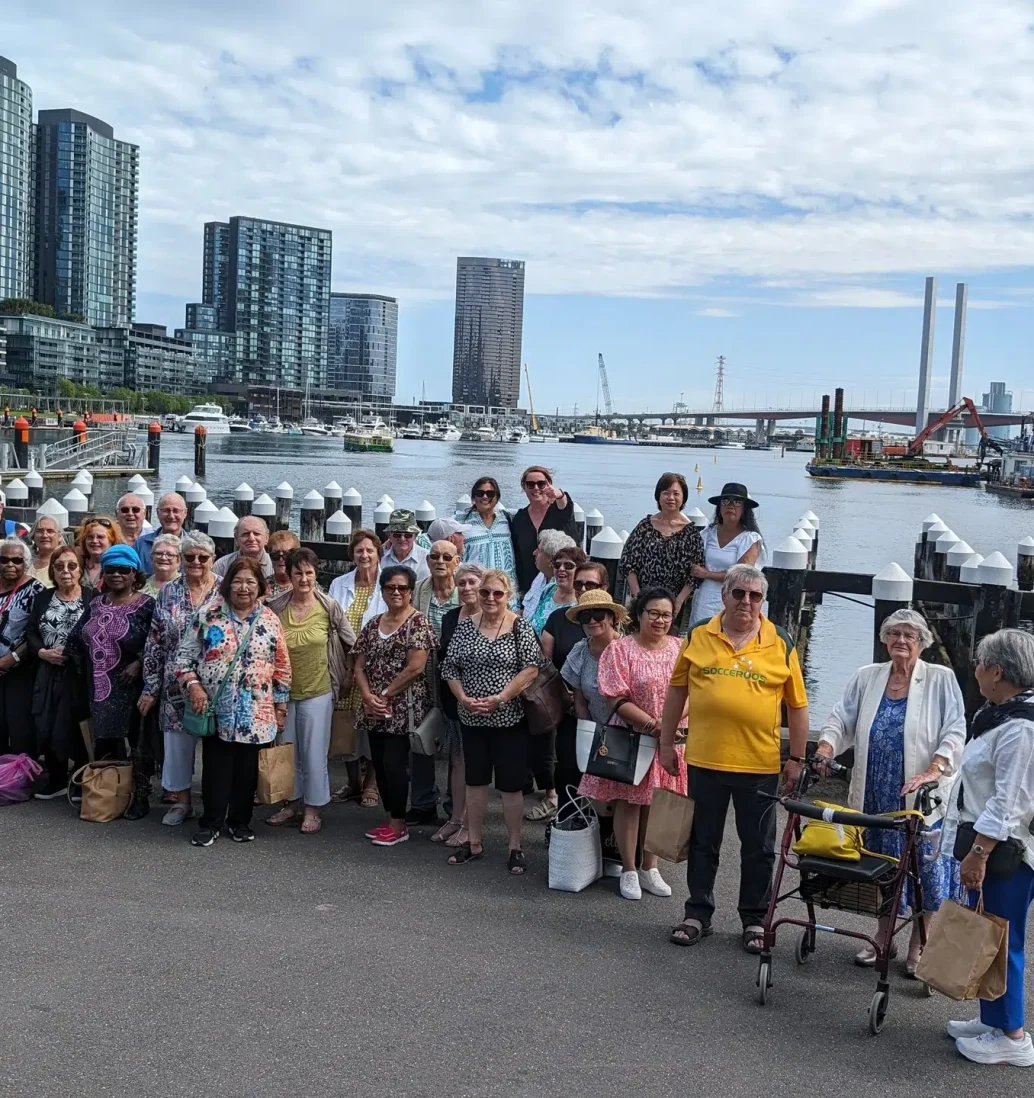 Group posing by riverfront skyline in Melbourne.